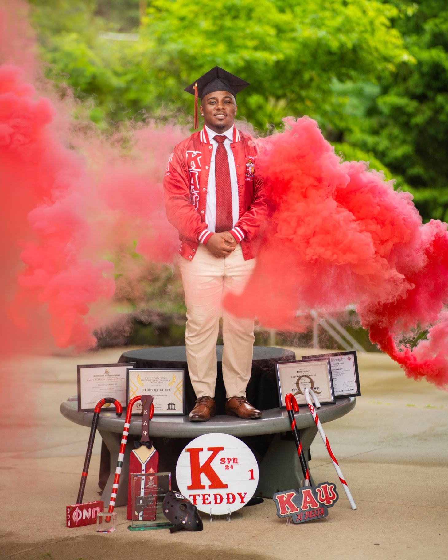 Graduate with red smoke bombs