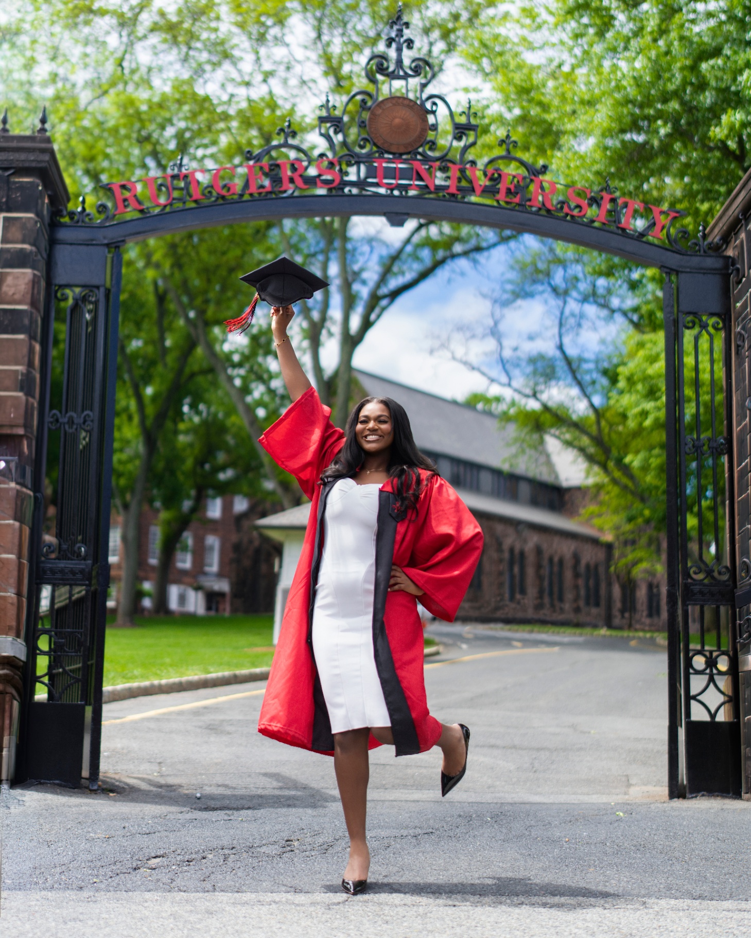 Rutgers grad celebrating under the university gate