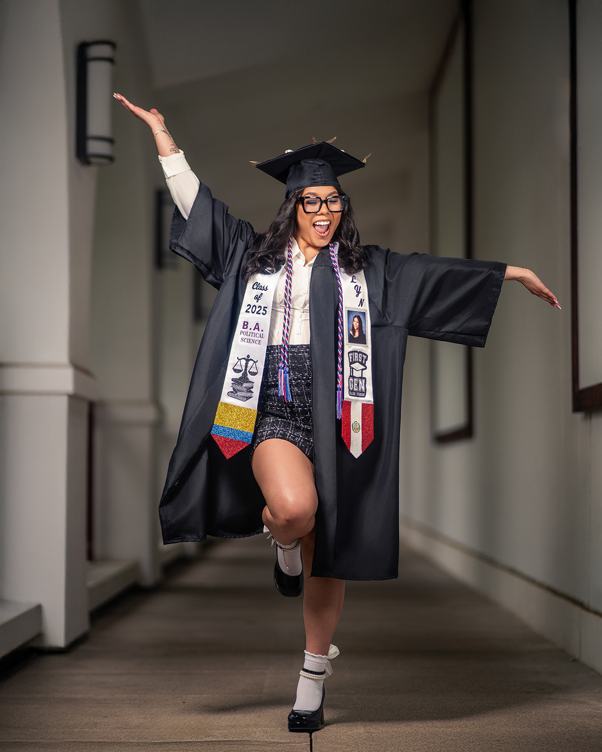 Political Science grad mid-leap in campus hallway