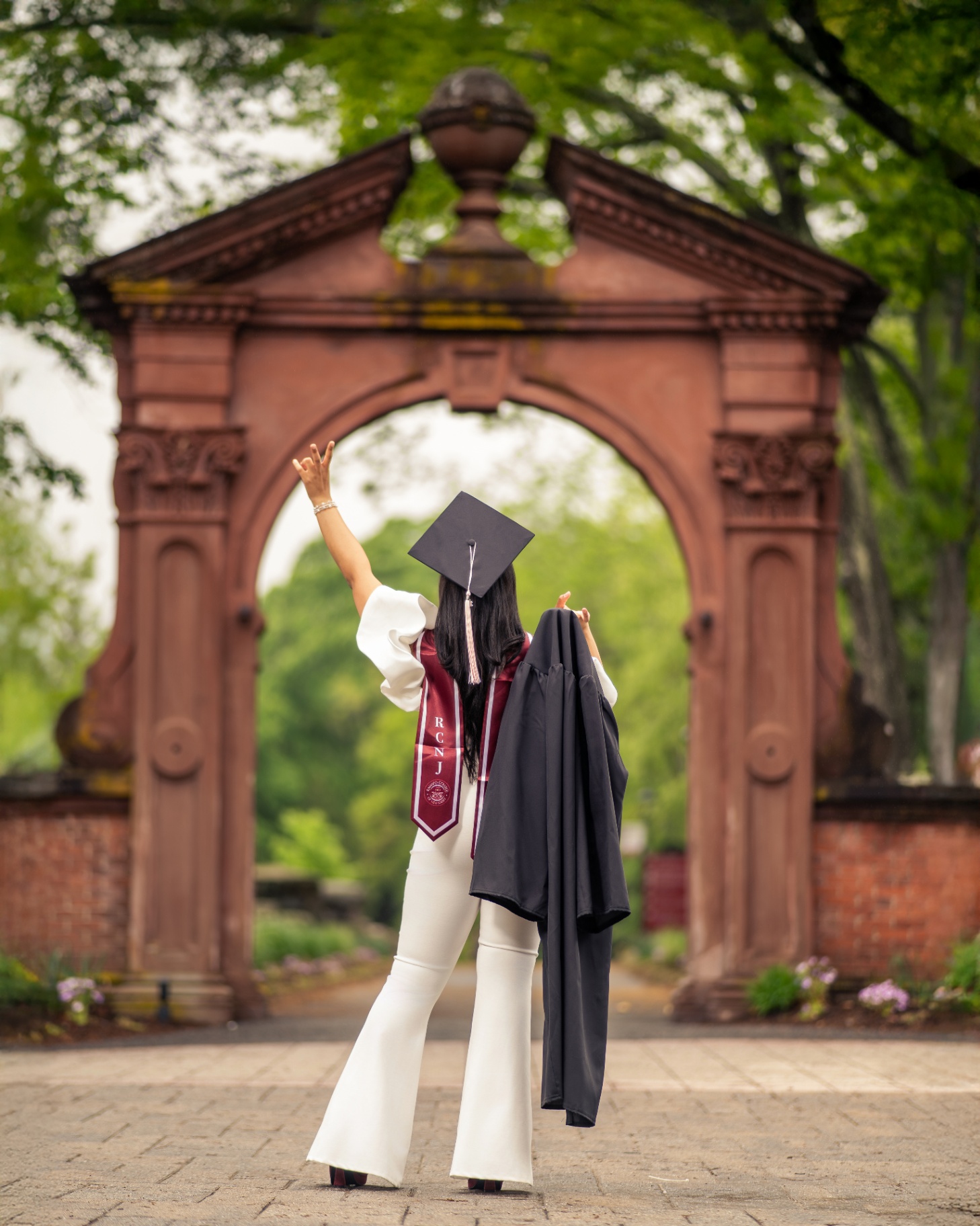 Ramapo grad from behind celebrating under the arch