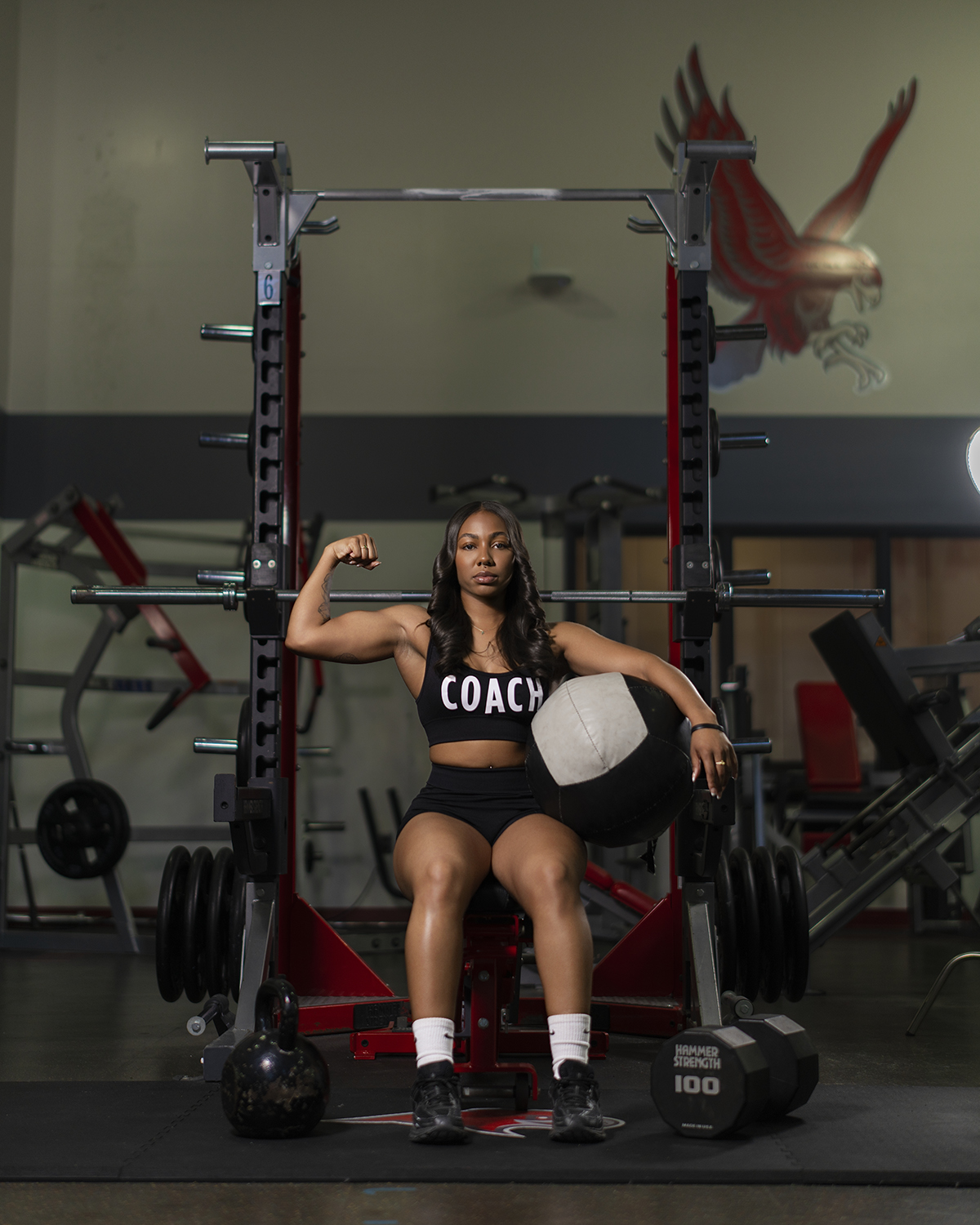 Coach flex portrait on squat rack with med ball