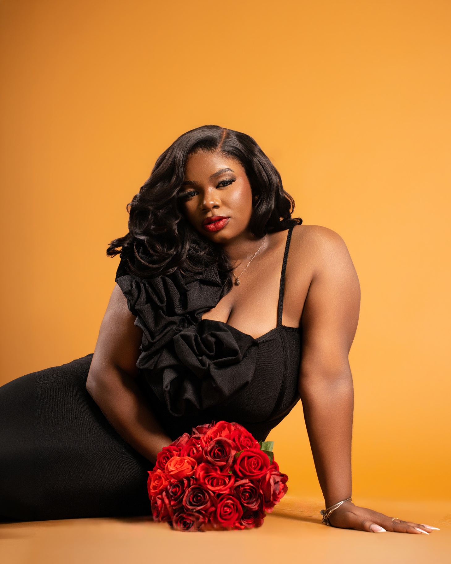 Black rosette gown on orange backdrop
