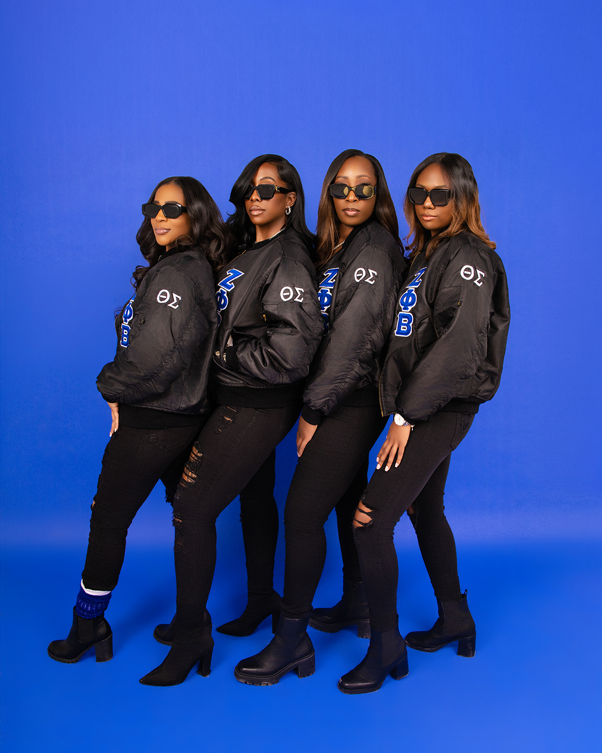 Zeta Phi Beta group profile — bomber jackets on blue