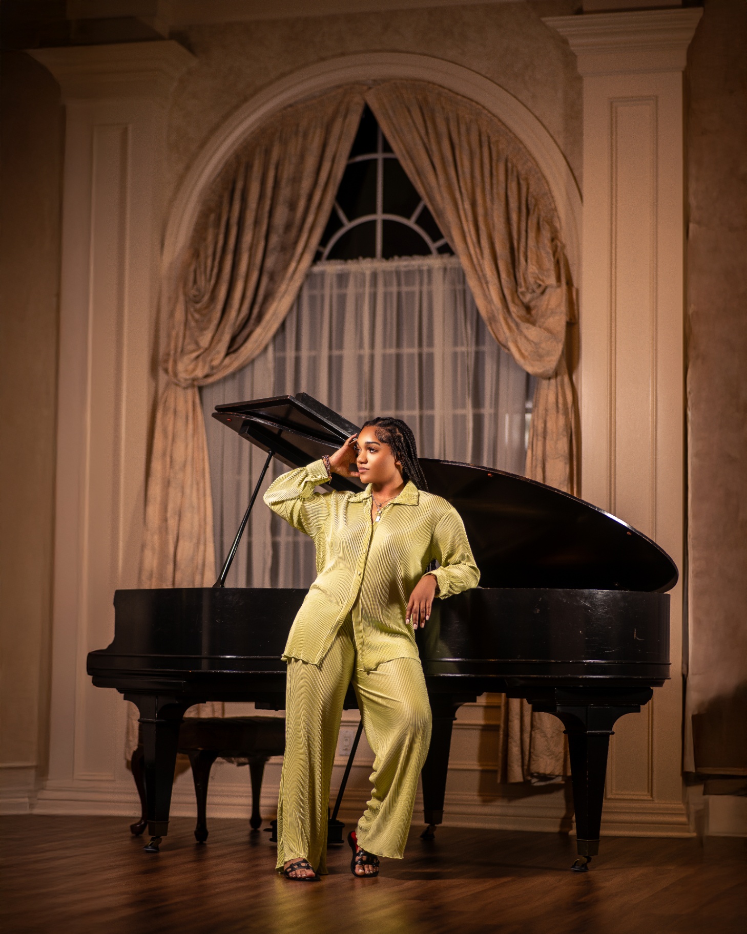 Chartreuse suit portrait by grand piano