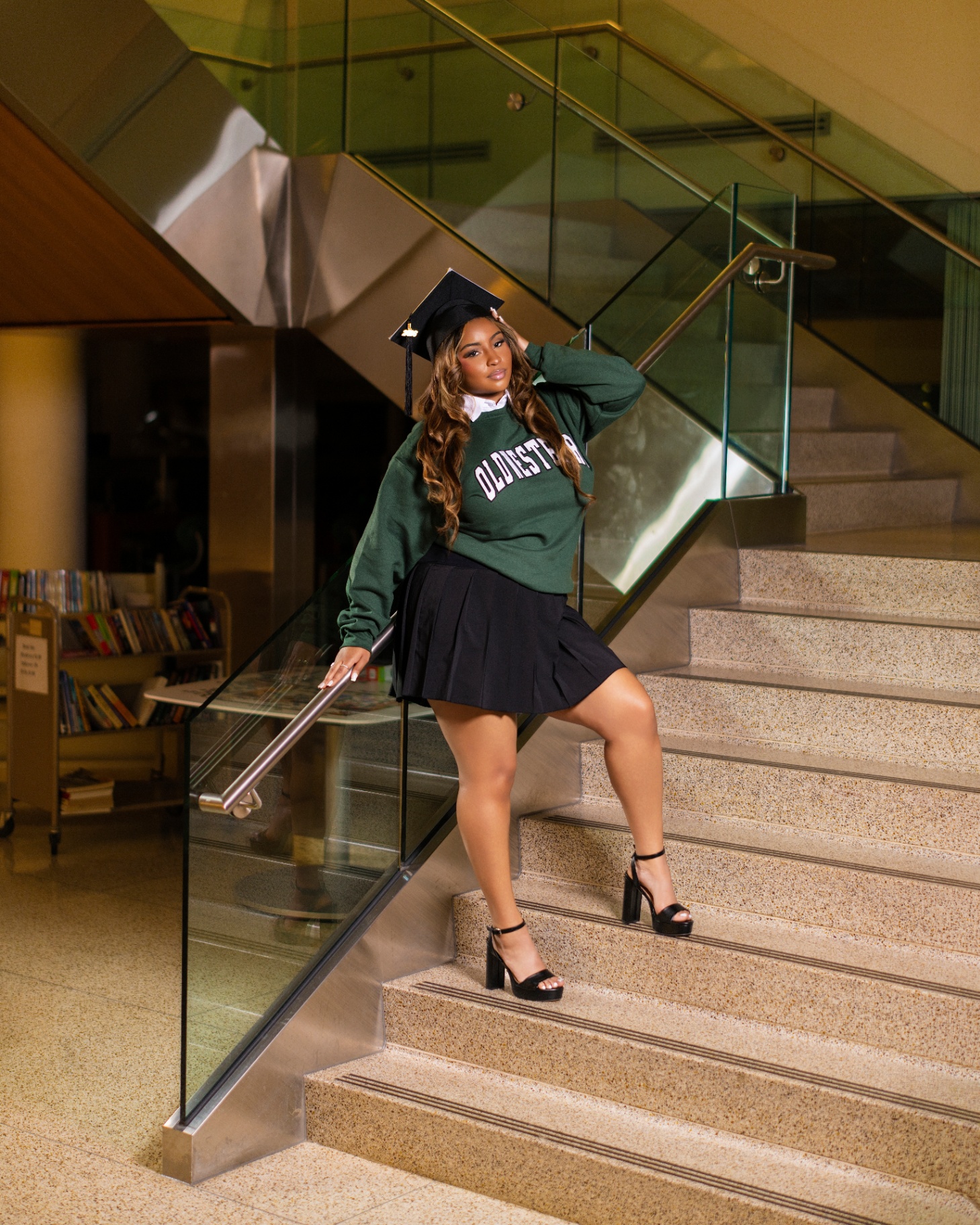 Old Westbury grad on library stairs