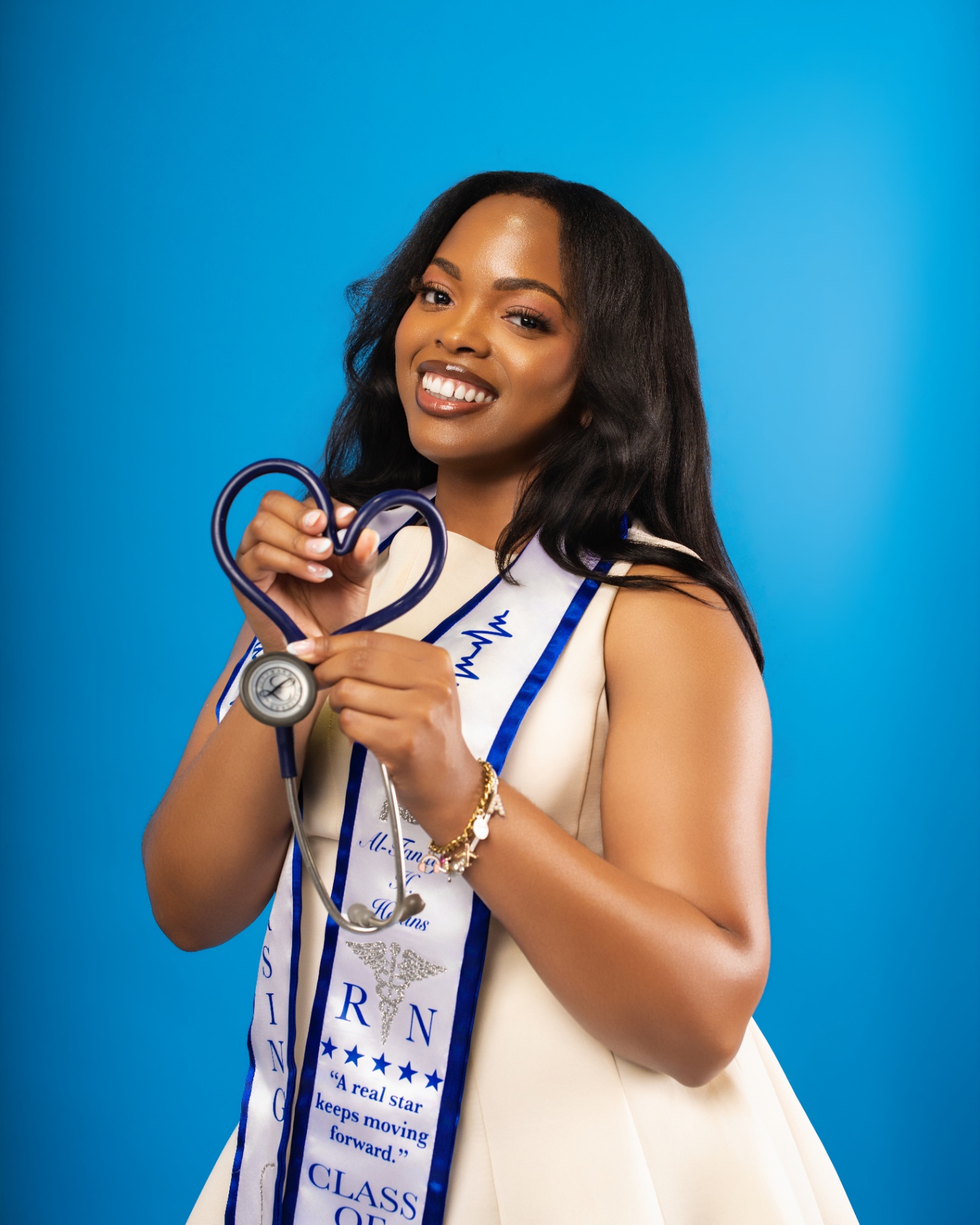 Nurse forming heart with stethoscope