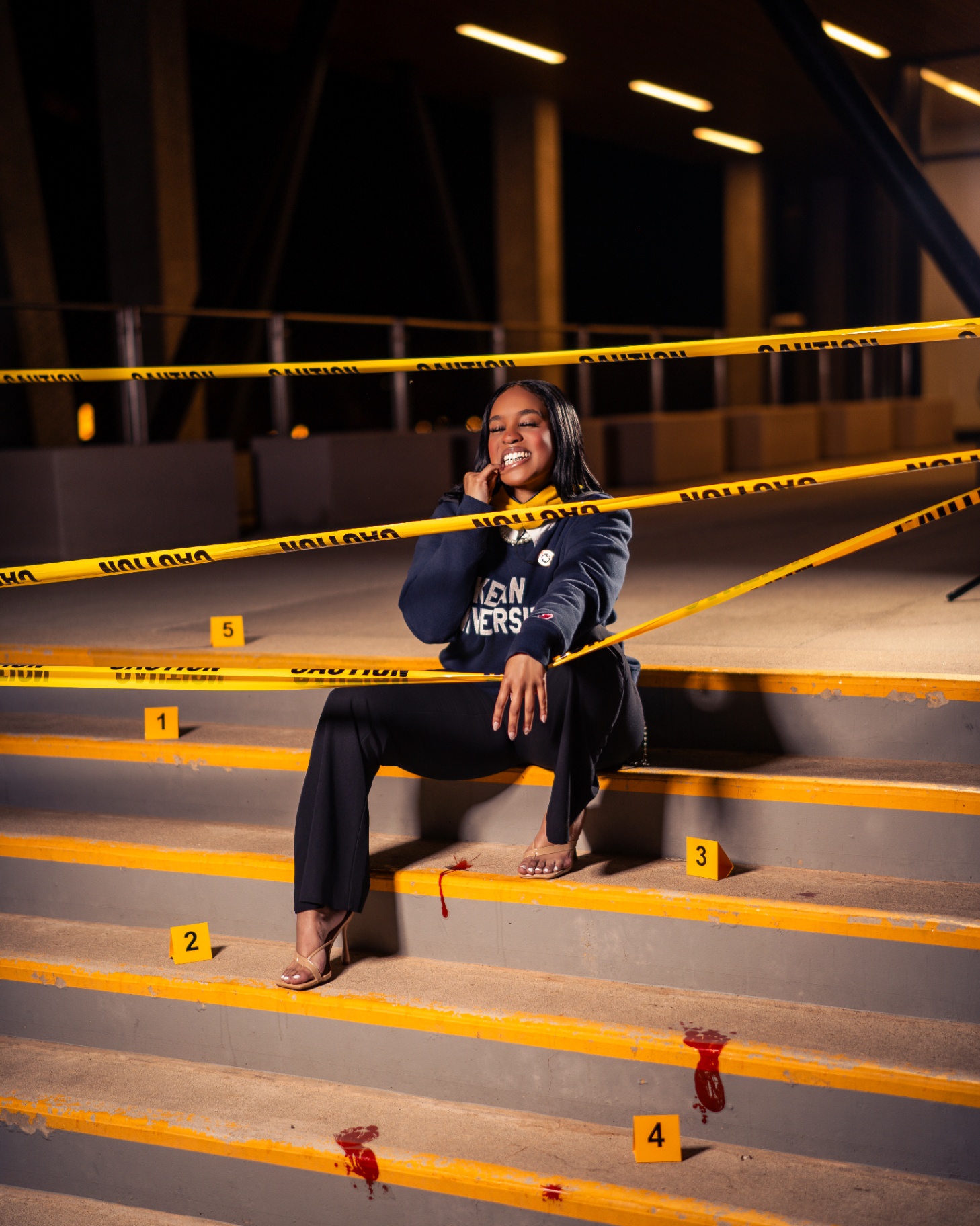 Kean grad in crime-scene themed shoot with caution tape