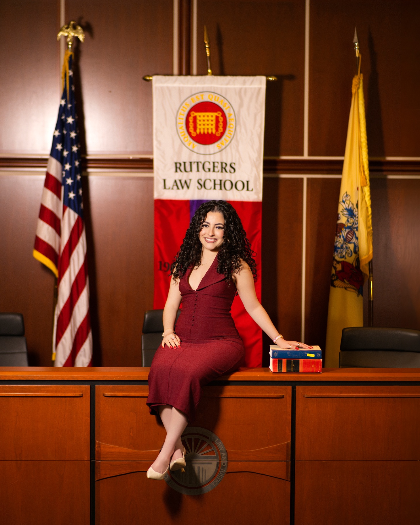 Rutgers Law grad on courtroom bench with law books