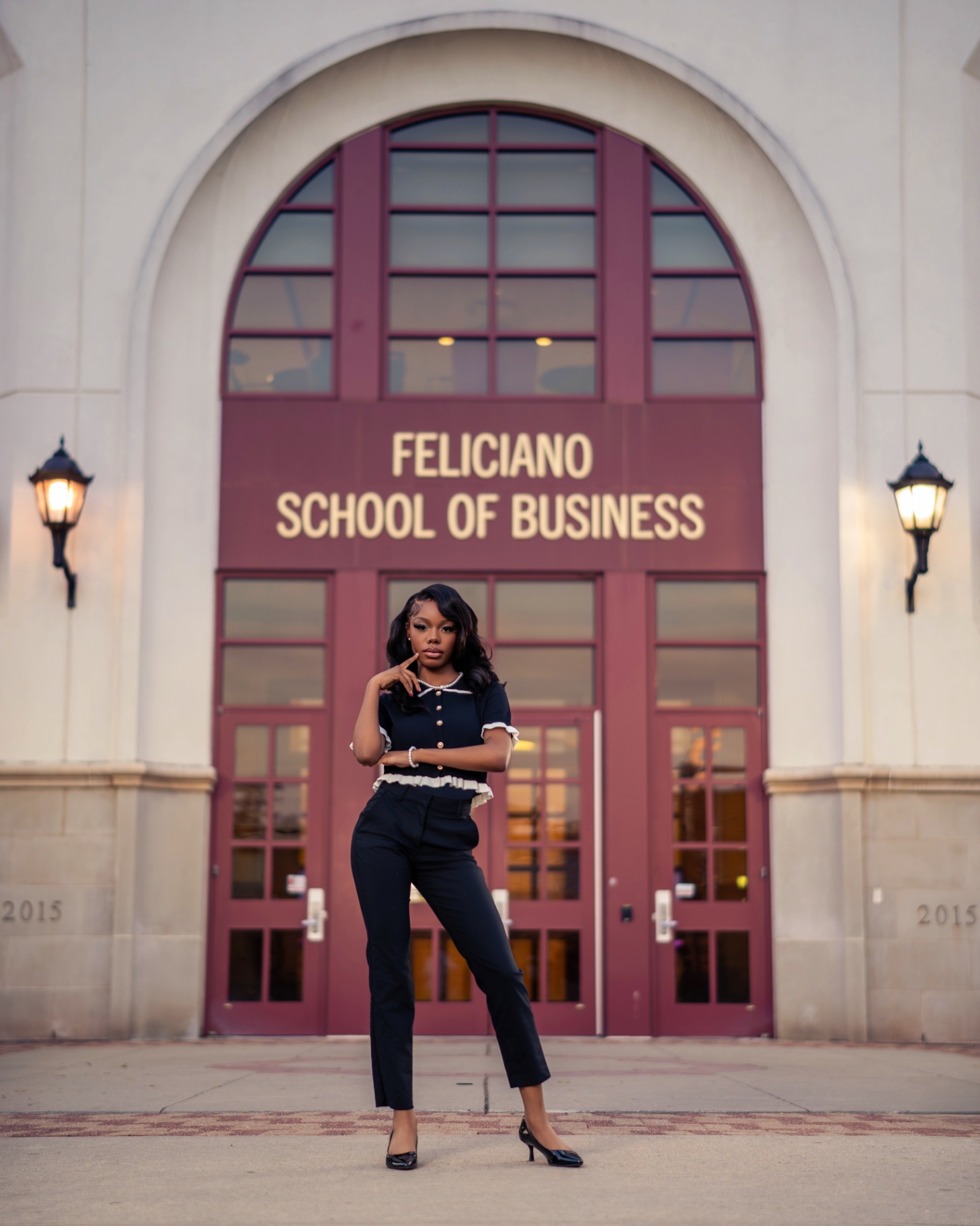 Graduate at Feliciano School of Business entrance