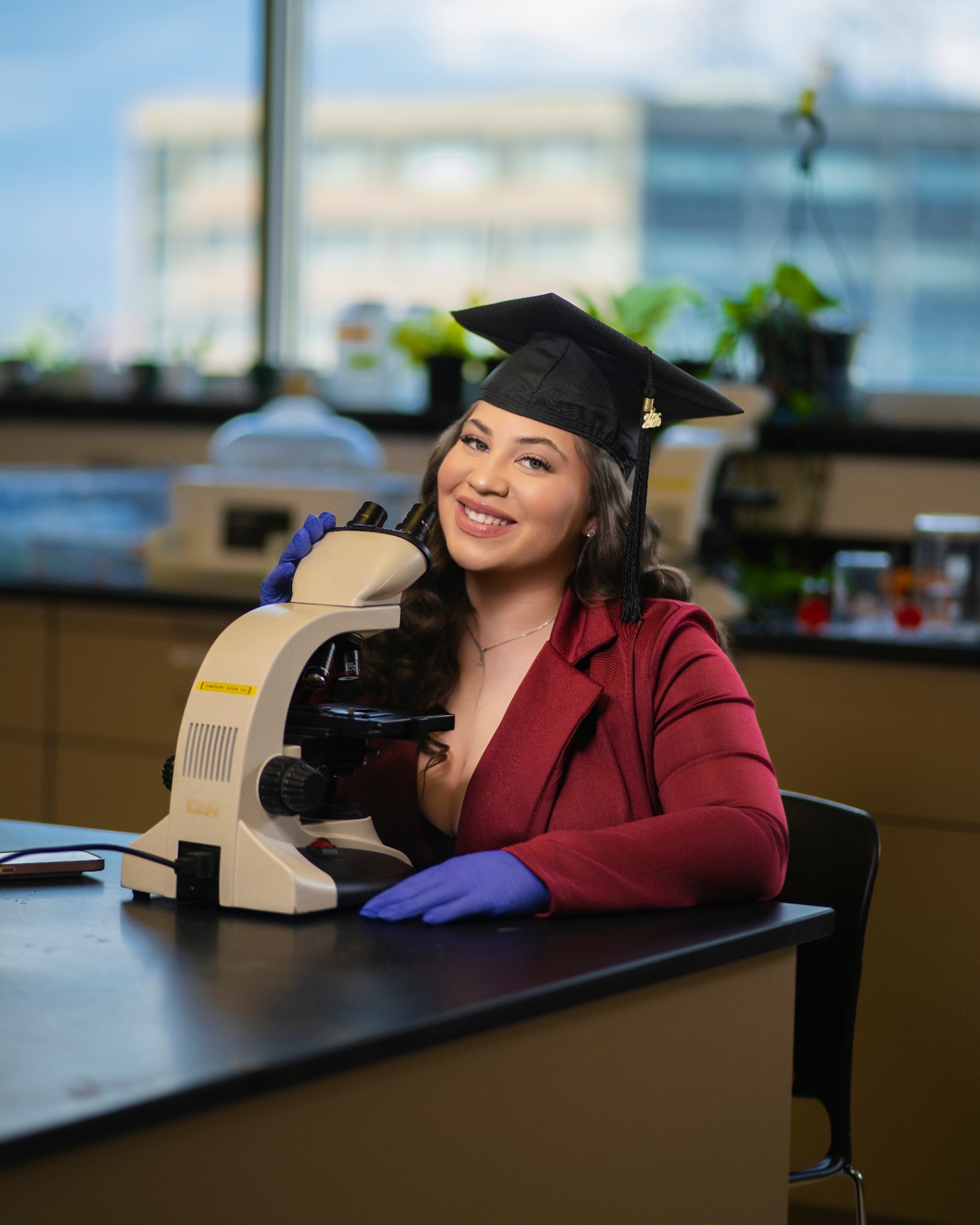 Science grad with microscope in laboratory