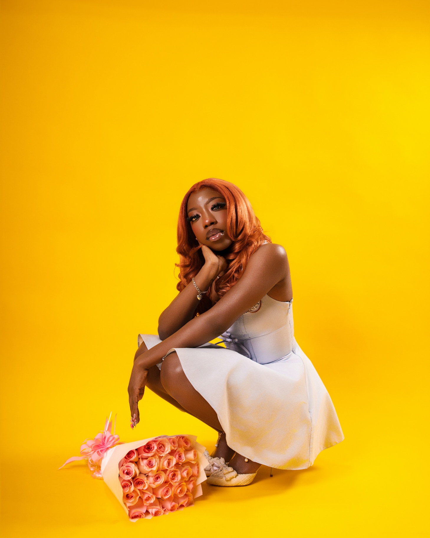 Ginger hair portrait with roses on yellow