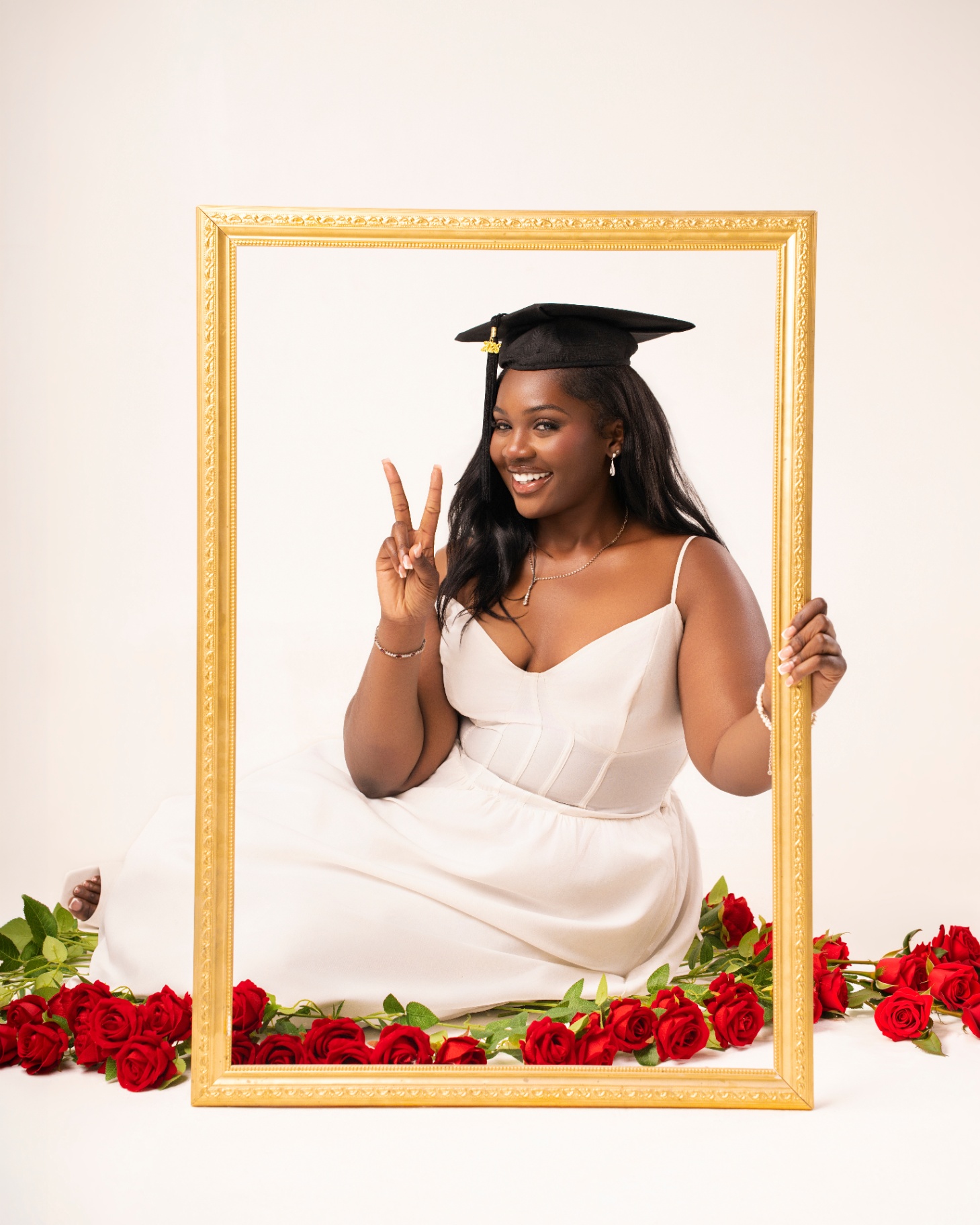 Graduate framed in gold with red roses