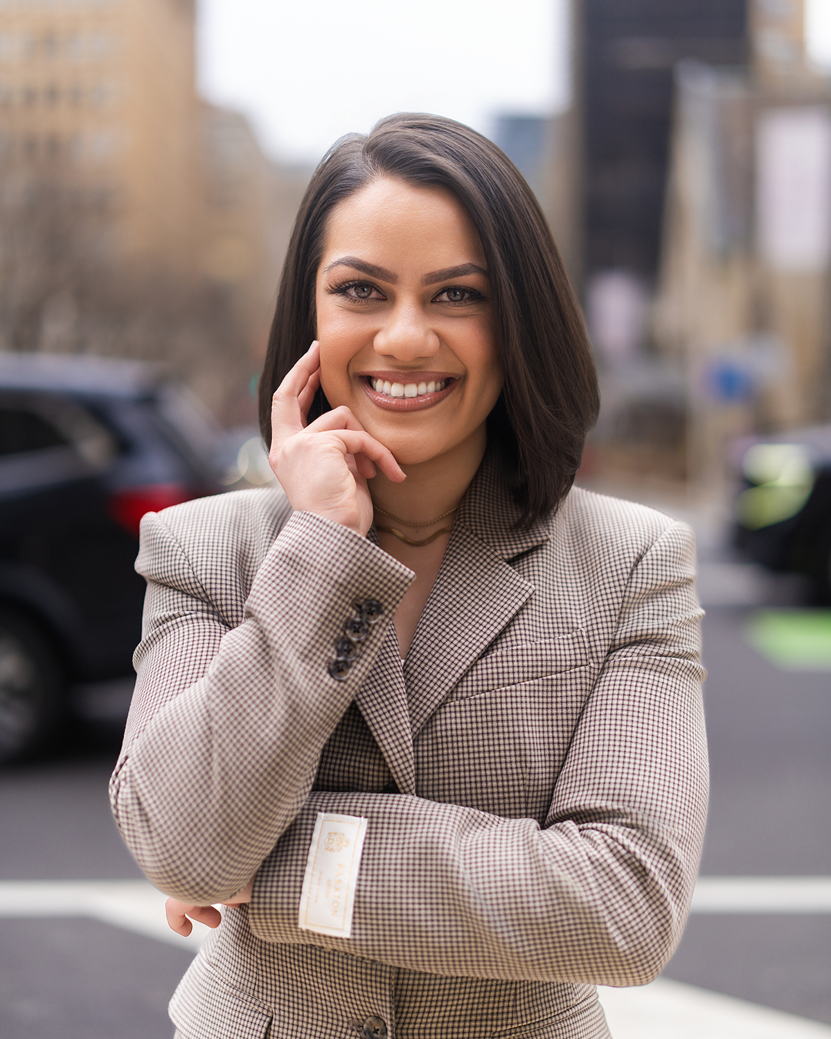 Corporate headshot in houndstooth blazer downtown