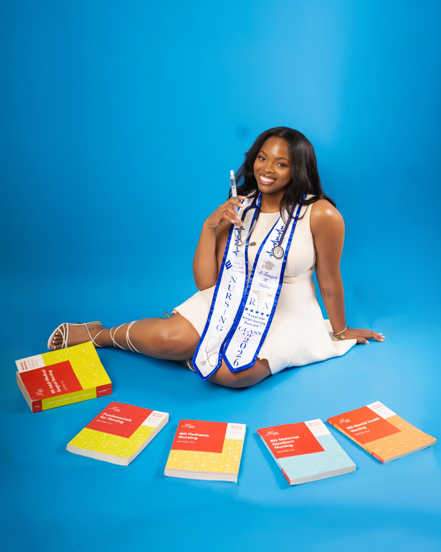 Nursing grad with textbooks