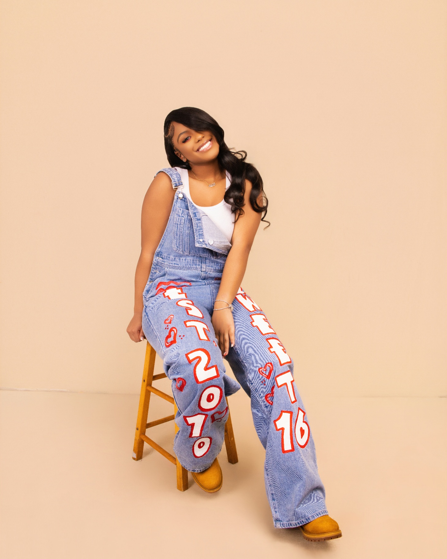 Sweet 16 denim overalls studio portrait