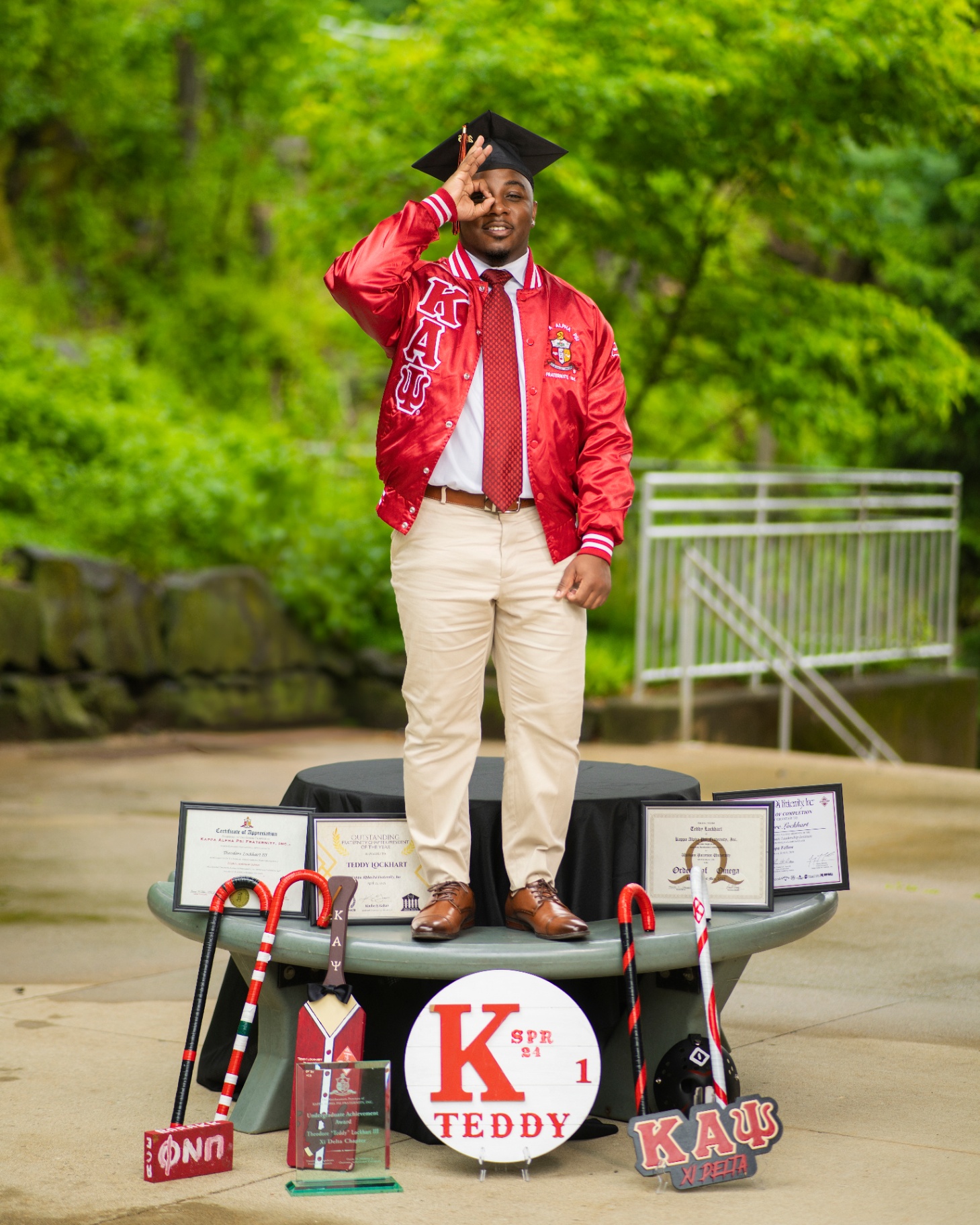 Fraternity graduate throwing signs