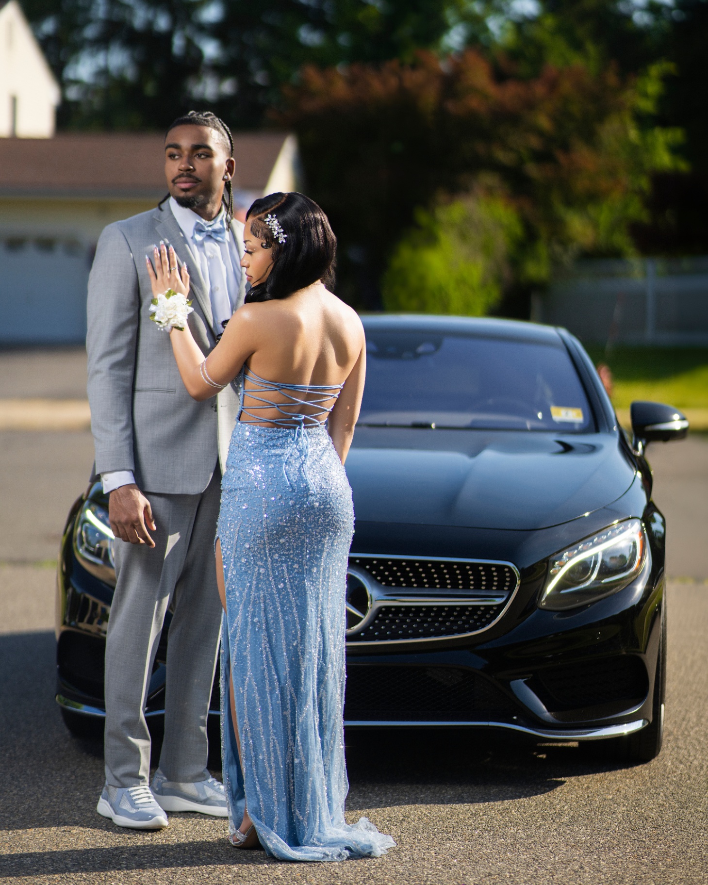 Prom couple by black Mercedes