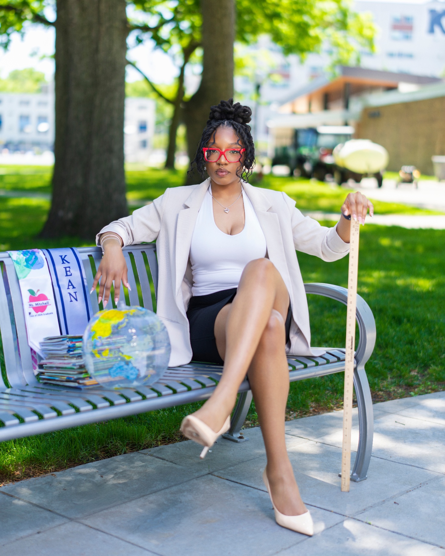 Teacher graduate on park bench