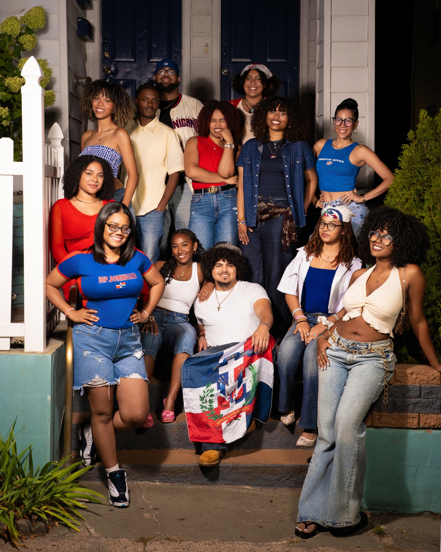 Dominican Republic group portrait on brownstone stoop with flag