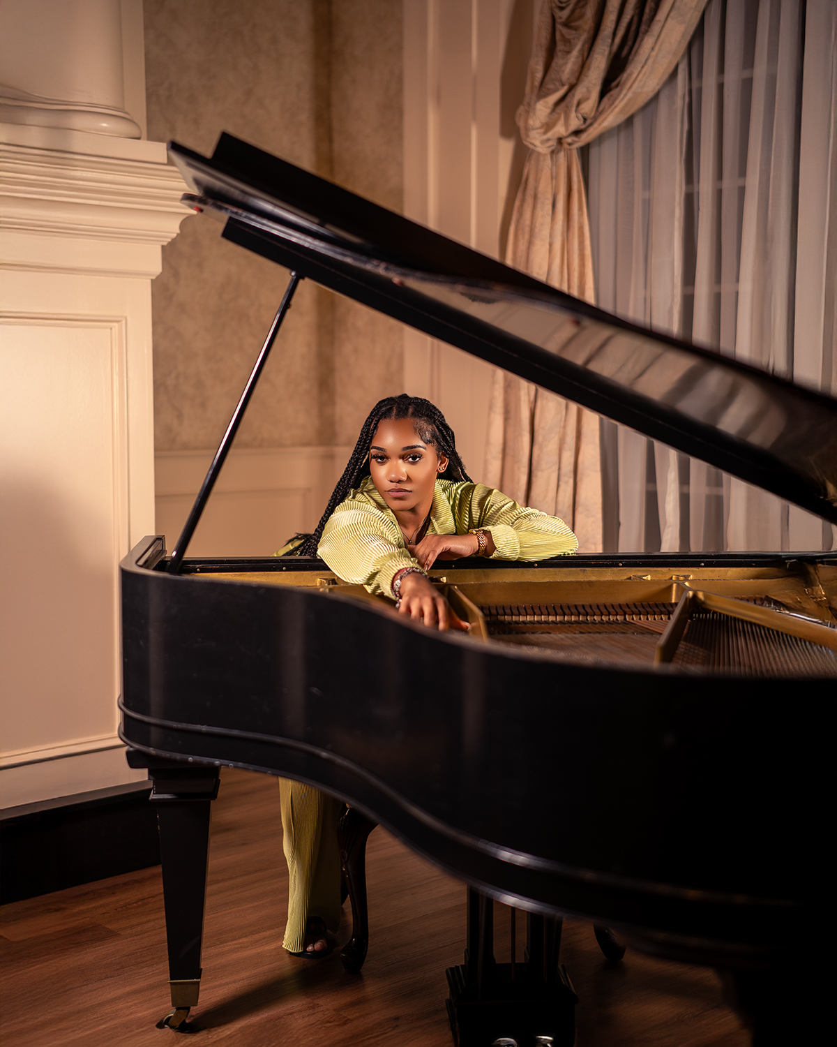 Editorial portrait leaning inside open grand piano