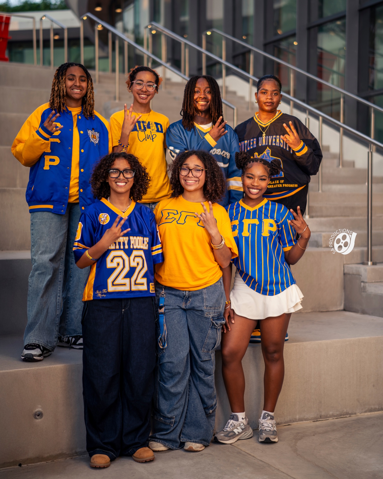 Sigma Gamma Rho group on campus steps at golden hour