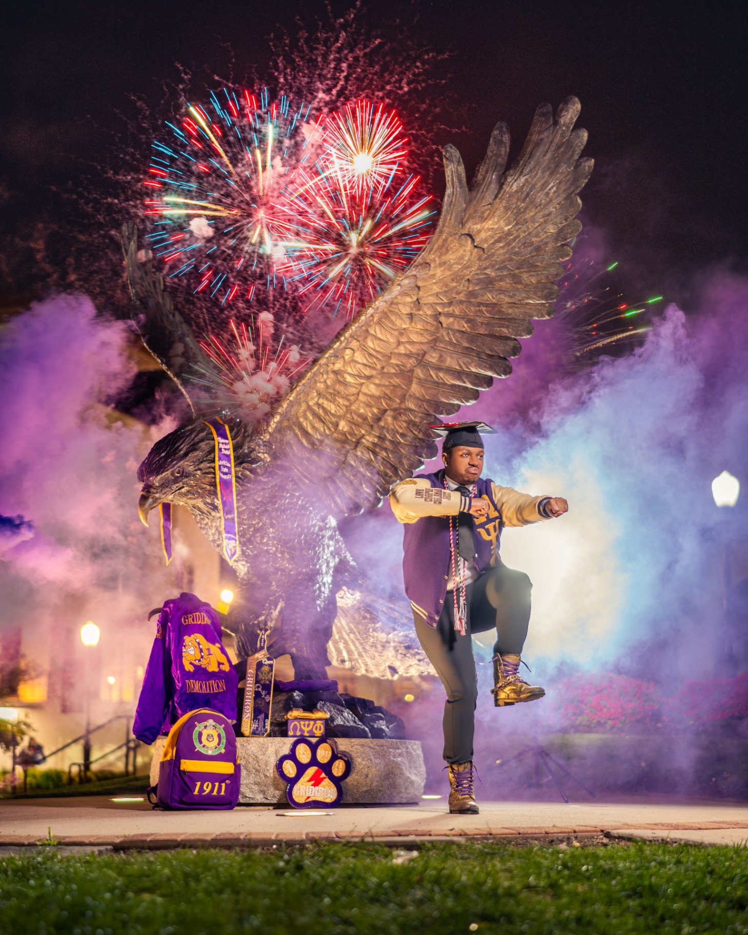 Omega grad with fireworks and eagle statue at night