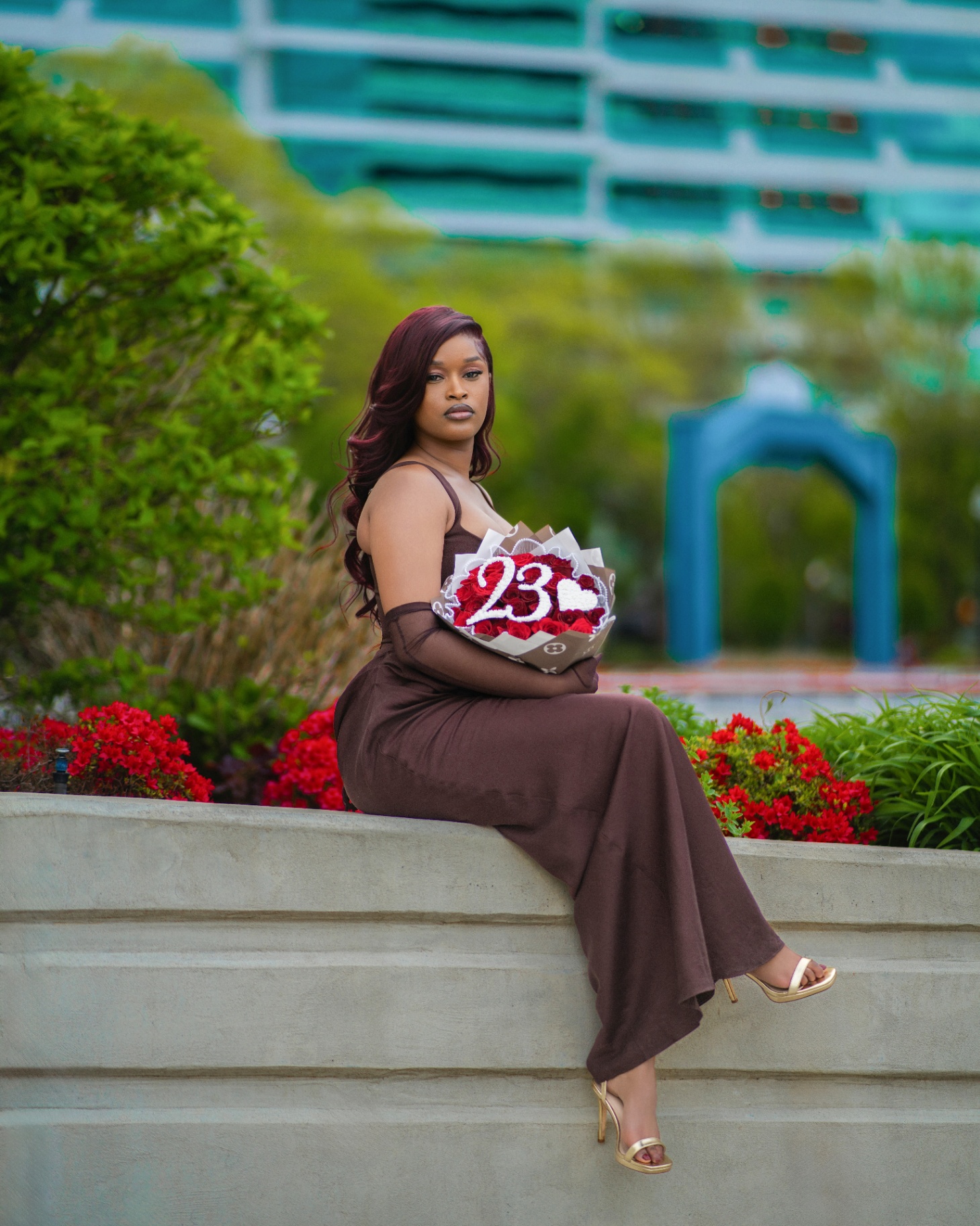 Grad with '23 rose bouquet by red azaleas