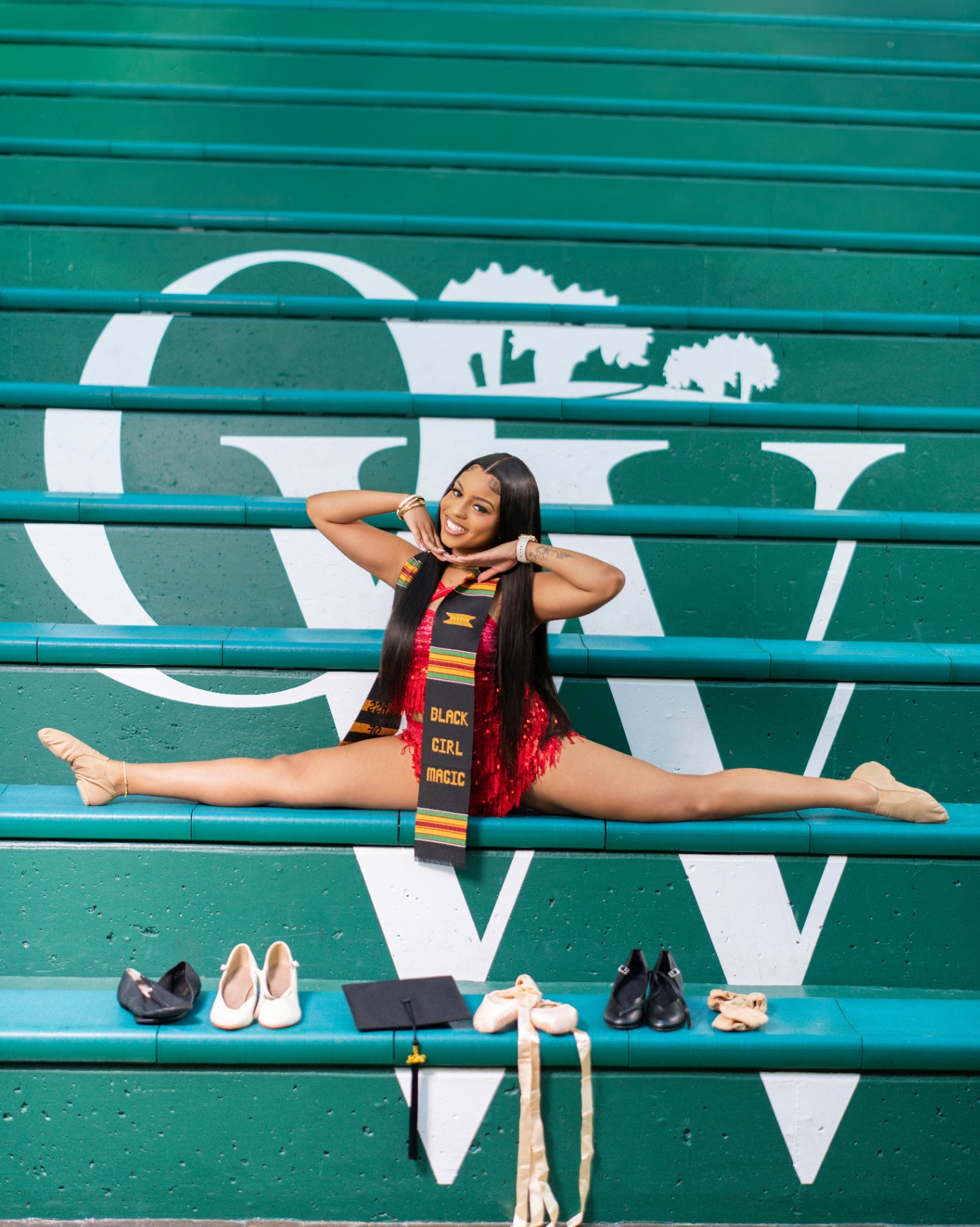 Dancer grad in splits on Old Westbury bleachers