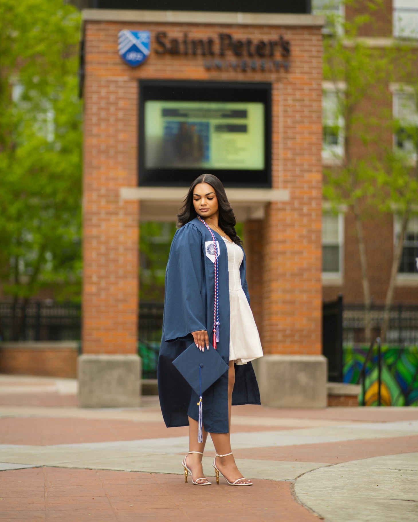 Saint Peter's University grad with cap and gown