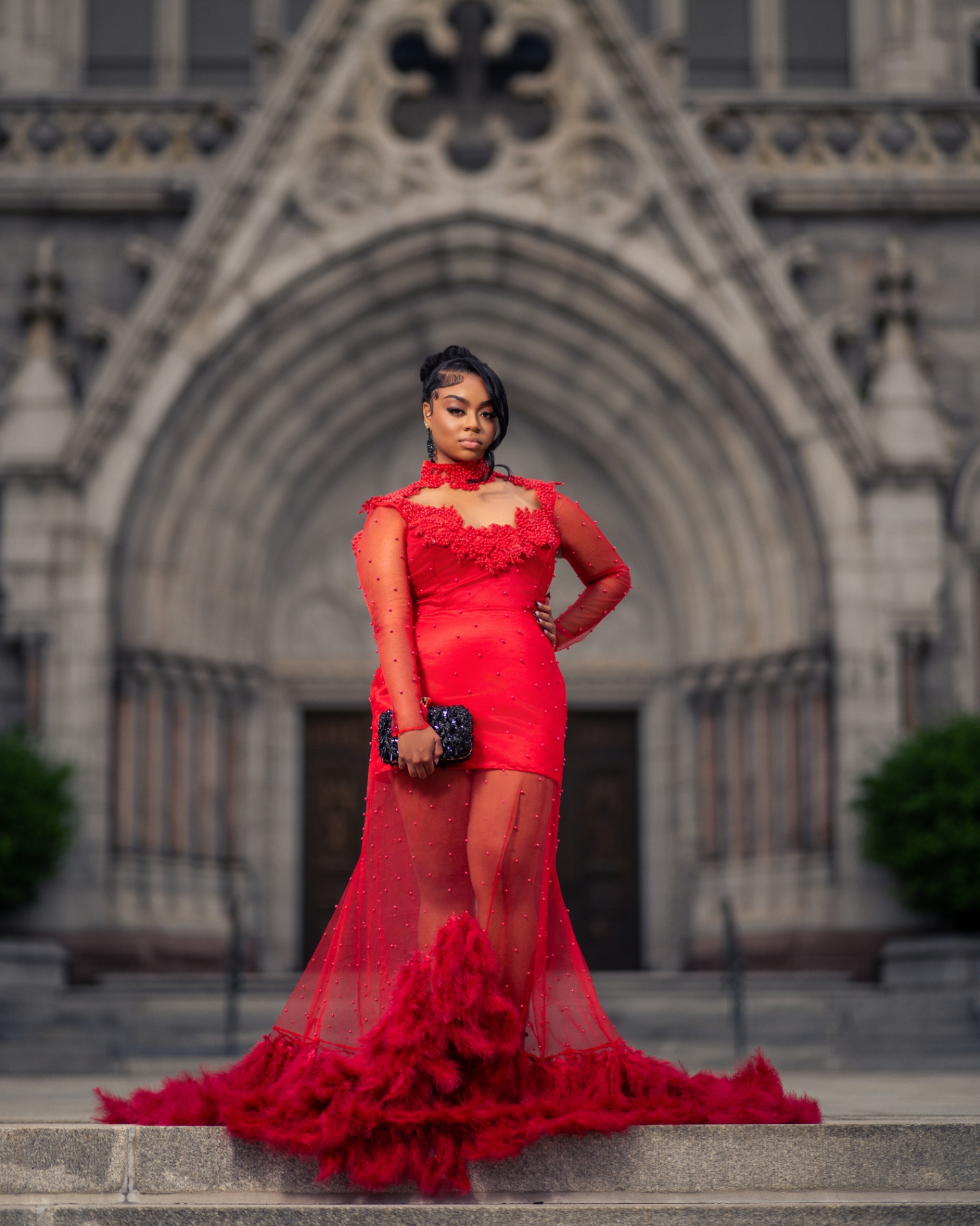 Red gown portrait at Gothic cathedral entrance