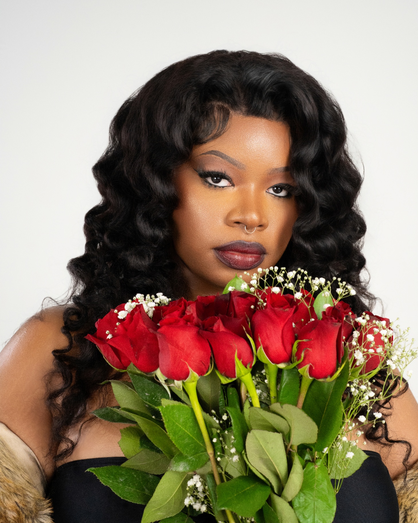 Portrait with red rose bouquet and fur