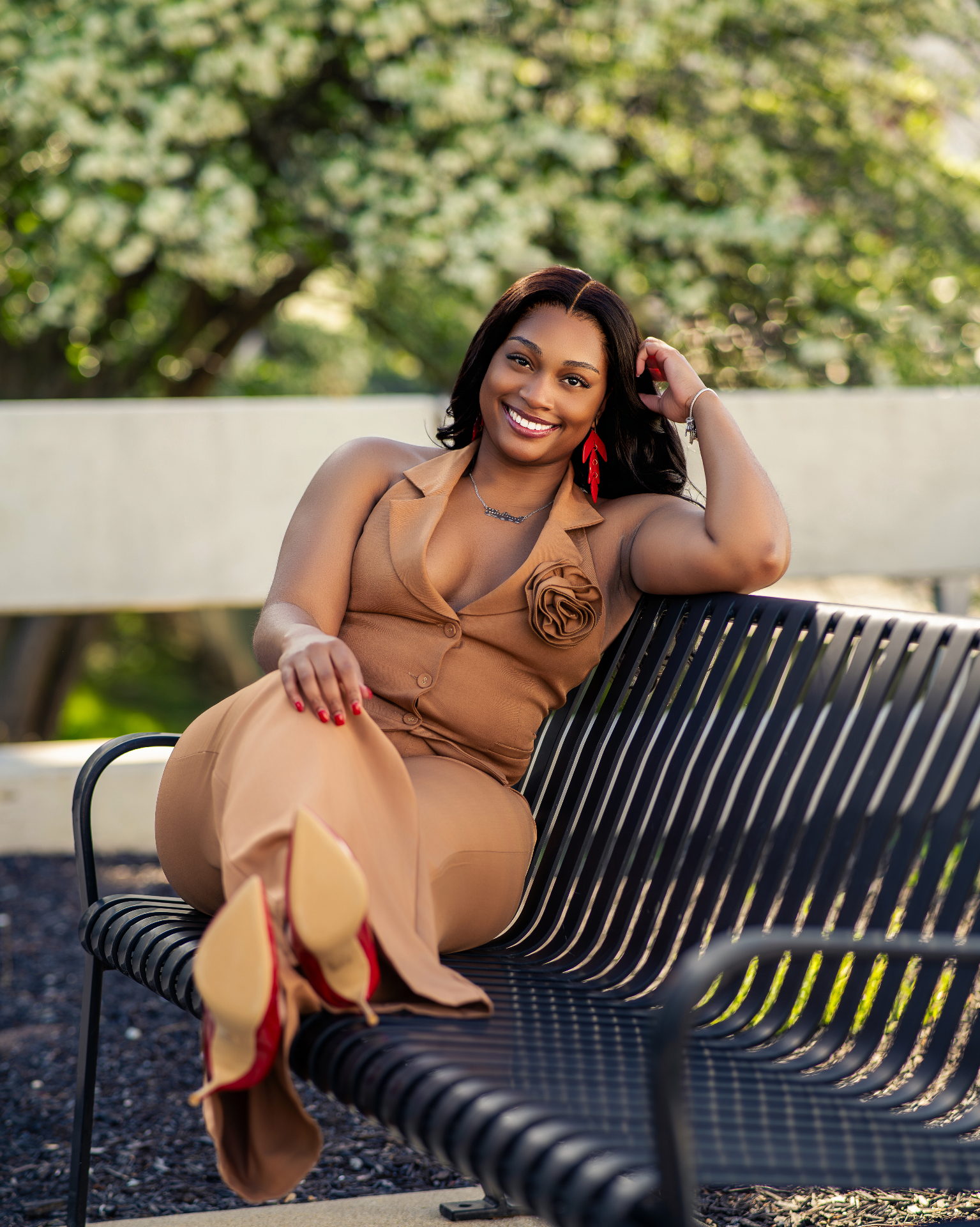 Tan outfit portrait reclining on park bench